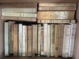 a box full of old books sitting on a table