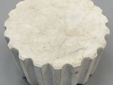 a close up of a white bowl on a table