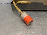an orange cord connected to a metal device on a table