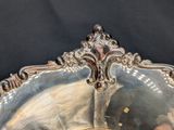 a silver plate with a mirror on it