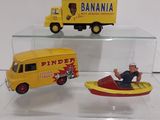 three toy vehicles that are on display in a glass case