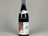 a bottle of red wine with sprinkles on it