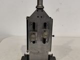 a picture of a small metal stove on a white surface