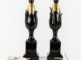 two black and gold vases with gold leaves on them