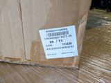 a cardboard box with a sticker on it sitting on the floor