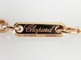 a close up of a gold chain bracelet with a name tag