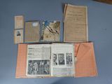 several old papers and papers on a table with a clock