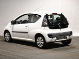 a small white car that is parked in a garage