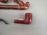 a pipe and a pipe holder sitting on a table
