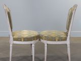 pair of white painted chairs with upholstered back and upholstered seat cushions