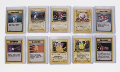 several pokemon cards are arranged in a row on a white surface