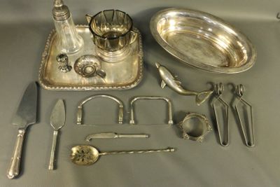 a silver tray with silverware and silver spoons and utensils