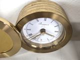 a gold clock with roman numerals on it