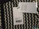 an image of a black and white shirt with a price tag on it