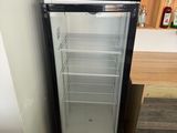 a refrigerator that is sitting in the corner of a room