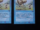 two cards with pictures of people in a field