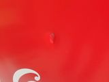 the side of a red coca cola machine with the word coca written on it