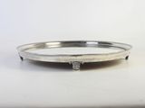a silver plate with a cross on it sitting on a table