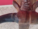 a statue of an elephant with a long tusk on it ' s head