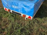 a blue tarp on the back of a trailer