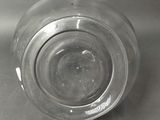 a clear glass with a small amount of water inside of it