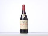 the bottle of red wine is sitting on the table