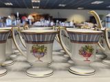 five cups and a teapot on a table