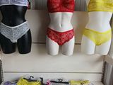 several mannequins and lingersuits are on display in a store