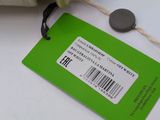 a white purse with a green tag attached to it