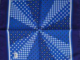 a blue banda with white polka dots on it