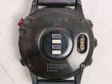a close up of a watch on a white surface