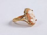a close up of a gold ring with a stone in the center