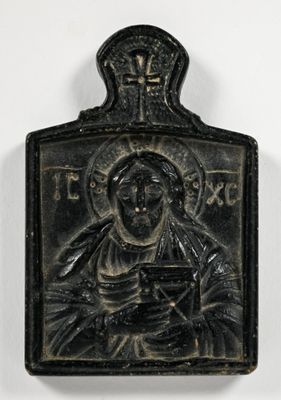 a black metal plaque with an image of a woman holding a baby