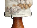 a white and brown hat on top of a wooden stand