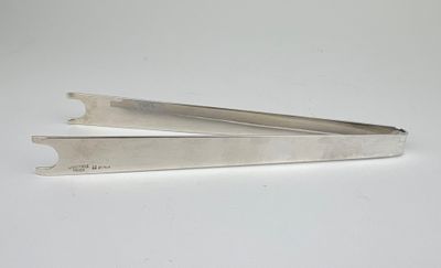 a pair of scissors sitting on top of a white table