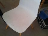 a white chair that is sitting in the middle of a room
