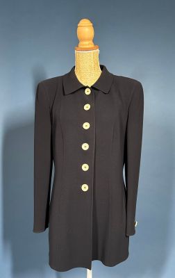 black coat with gold buttons on a mannequin base