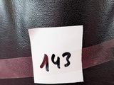 a black hat with a red ribbon and a label on it