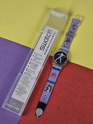 a watch that is laying on a colorful surface