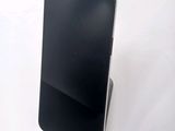a cell phone that is sitting on top of a stand