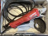 a red electric tool in a box with other tools in it
