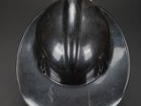 an old fireman ' s helmet on a black background