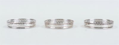 three silver rings sitting on top of each other on a white surface