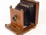 an old camera that is sitting on a white surface