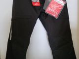 black pants hanging on a hanger in a closet next to a door