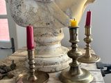 a bust of a woman sitting on top of a table with candles