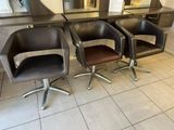 three chairs that are sitting in front of a mirror