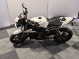 a white and black motorcycle parked on a checkered floor