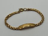 a gold bracelet with a curved clasp on a white background
