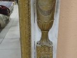 a mirror with a gold vase on it and a mirror with a gold vase on it